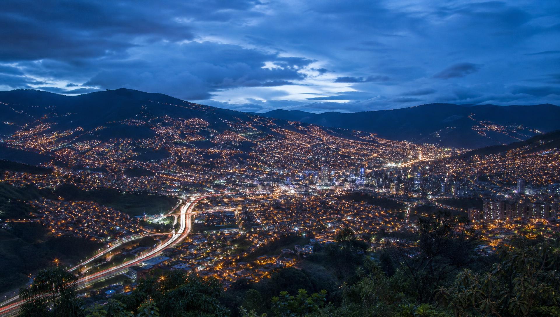 Aerial view of the Medellín valley at dusk with highways and city lights
