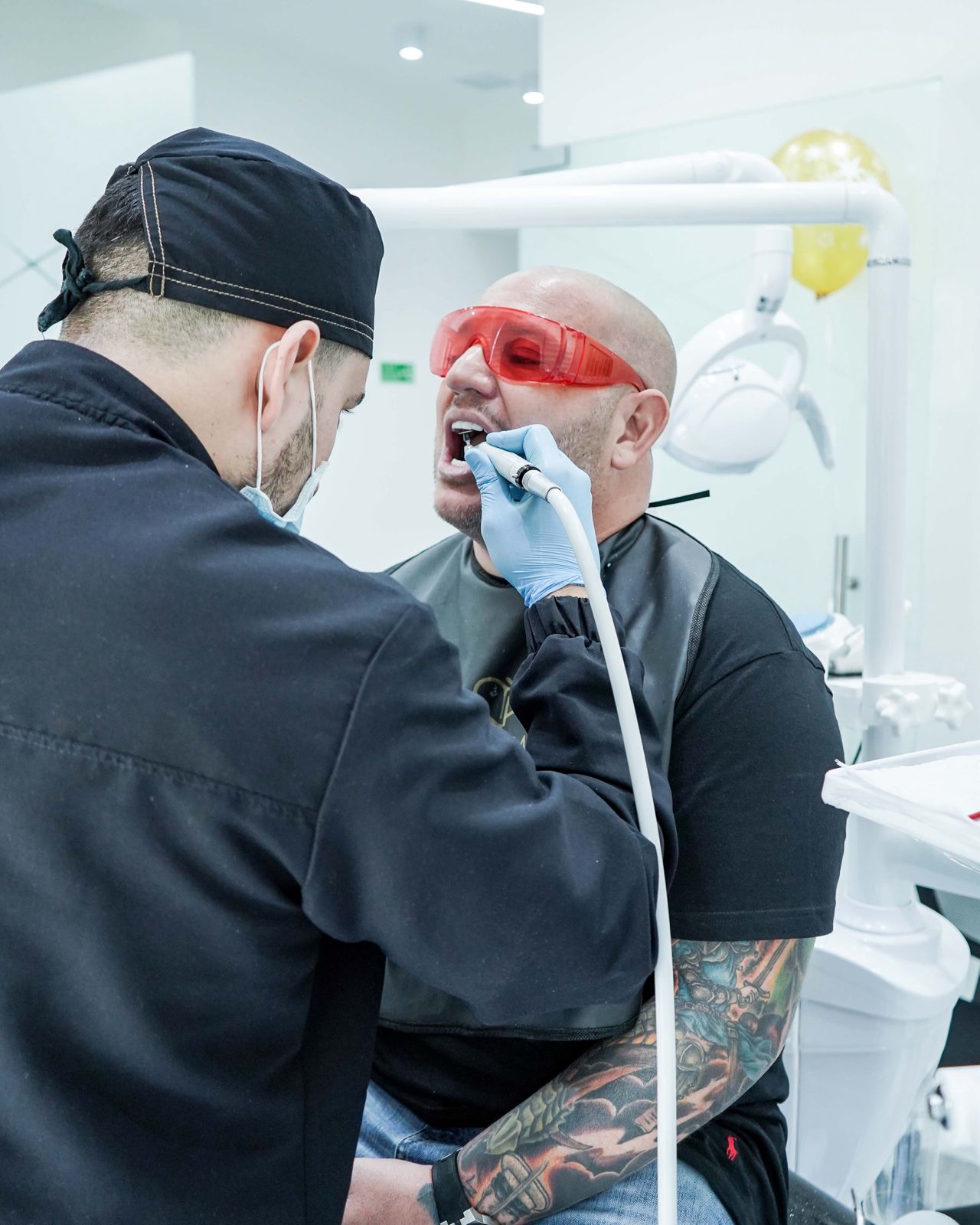 Surgeon performing dental procedure in Medellín clinic