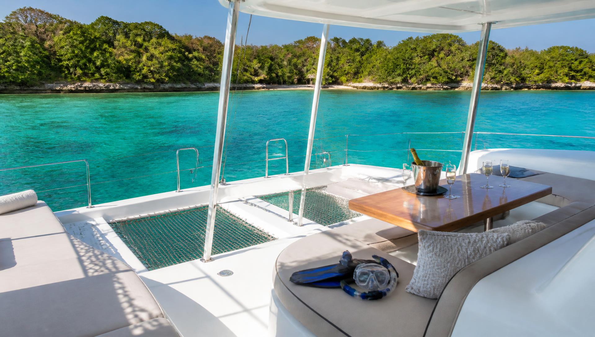 Catamaran deck anchored over clear turquoise water at the Rosario Islands
