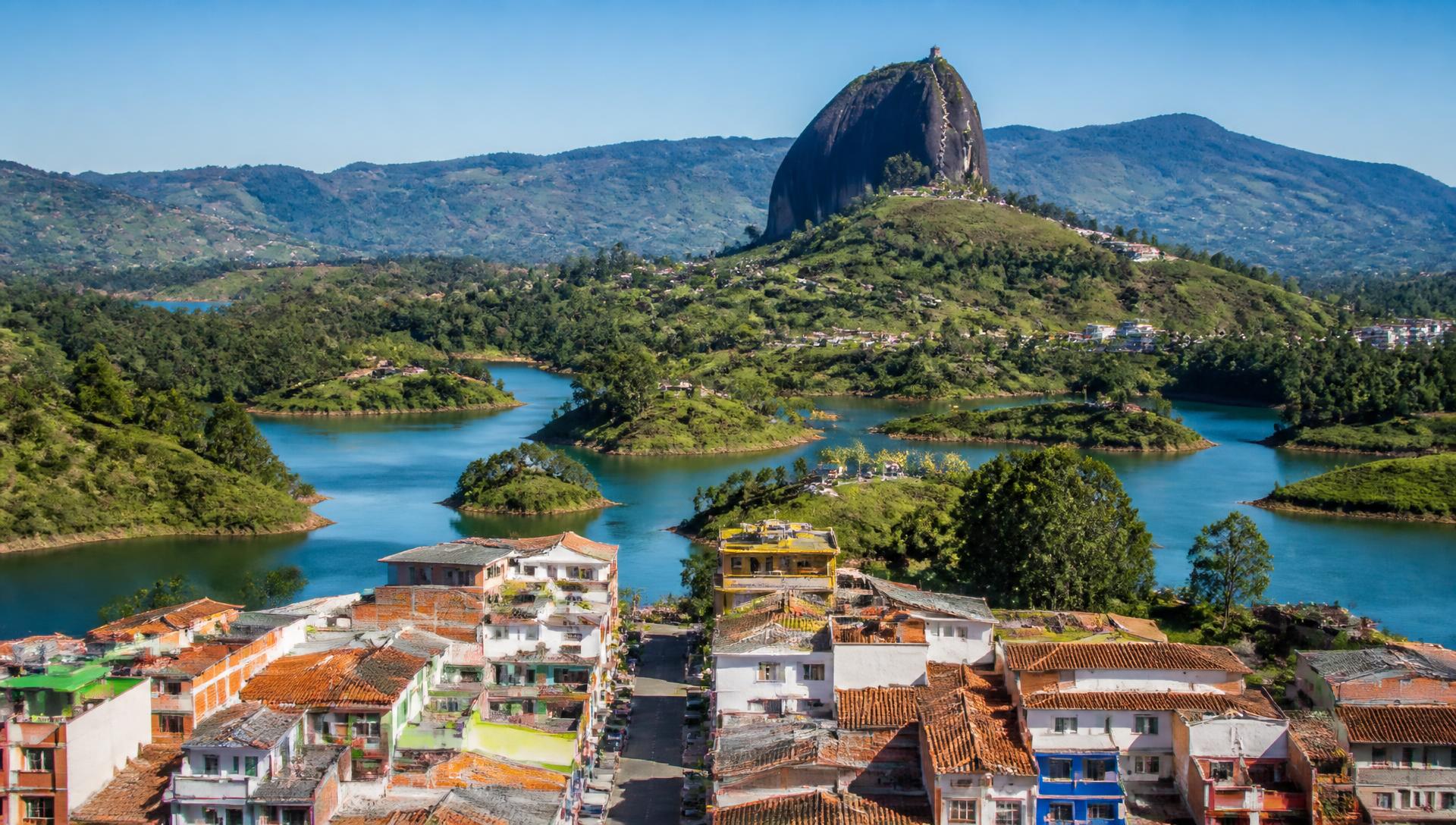 Guatapé town with the great rock and turquoise lakes behind it