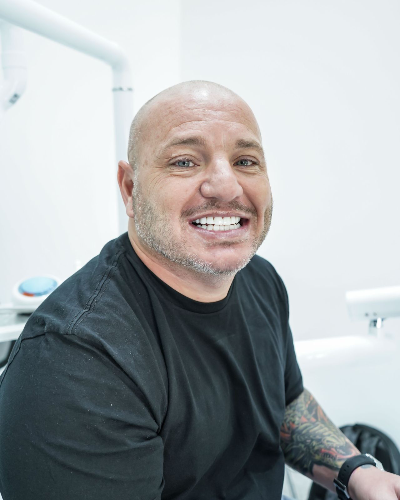 Patient smiling after full smile restoration in Medellín