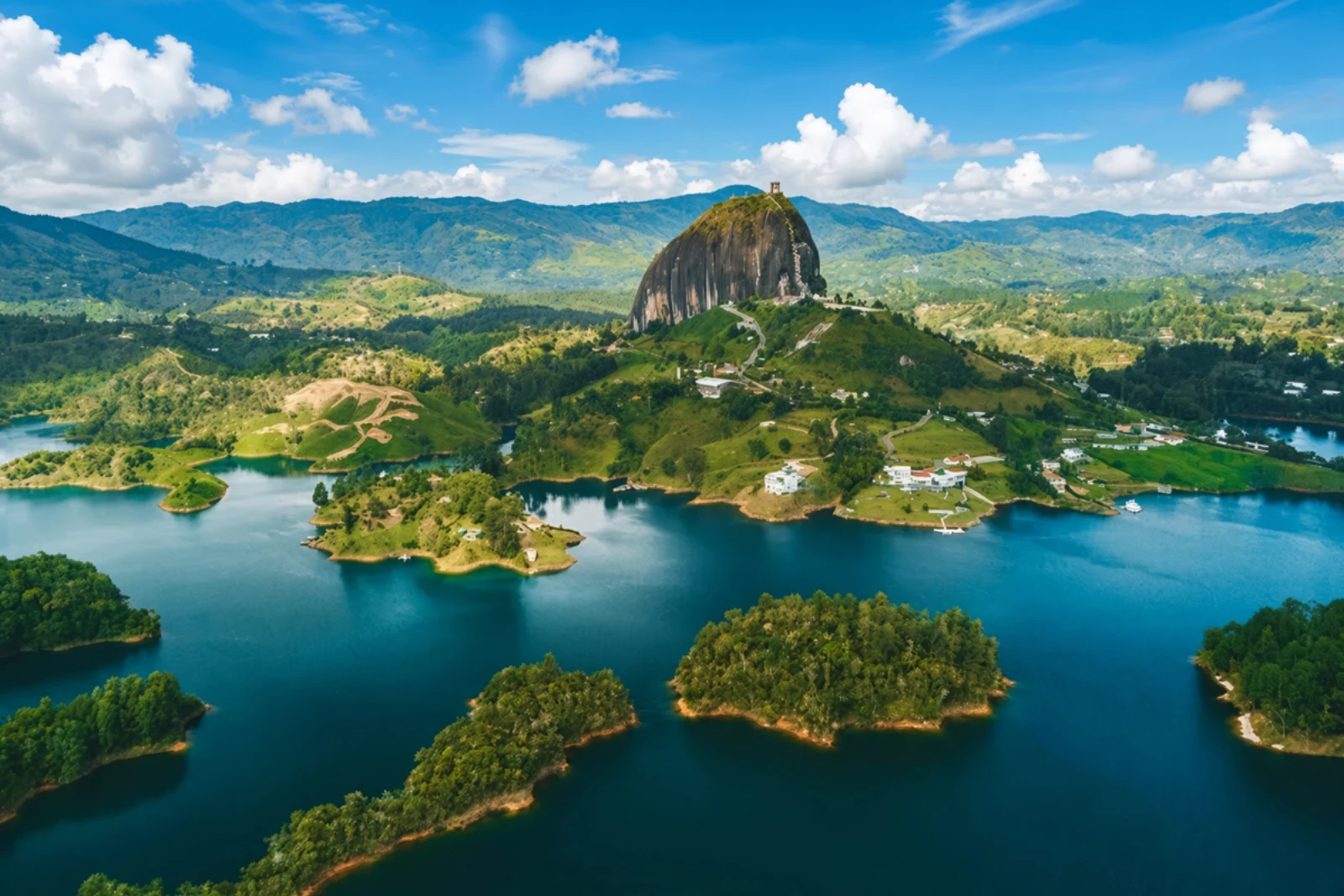 El Peñol rock rising over the emerald Guatapé reservoir in Colombia